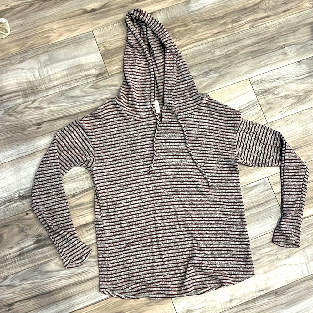 Striped light sweater with hood and peek a boo shoulders